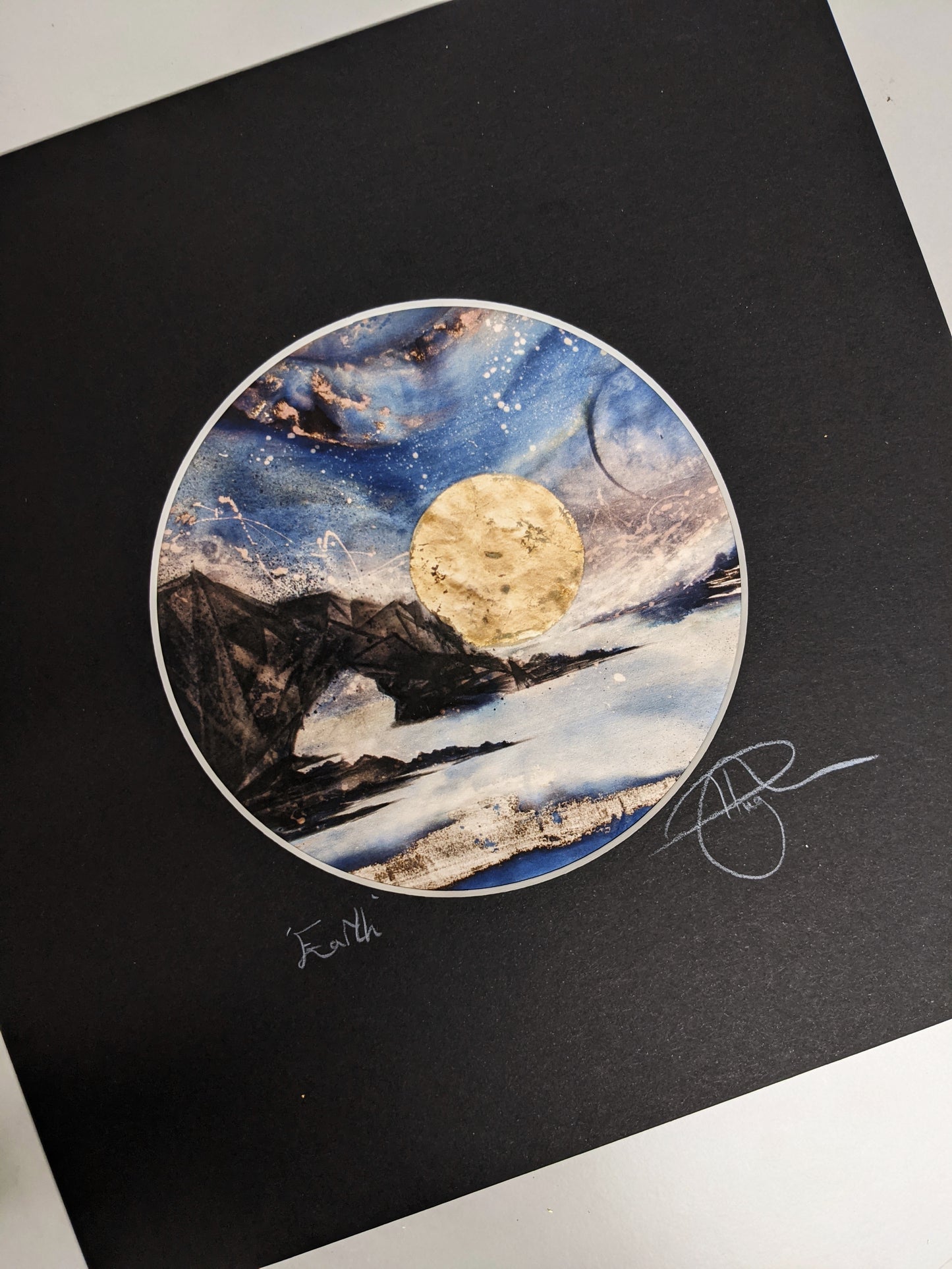 Earth | The sun sets behind an earthly rock formation jutting form the ocean under a kaleidoscopic celestial sky | Hand embellished Print | By Hannah Pugh